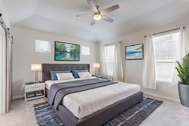 bedroom featuring light carpet, vaulted ceiling, baseboards, and a barn door