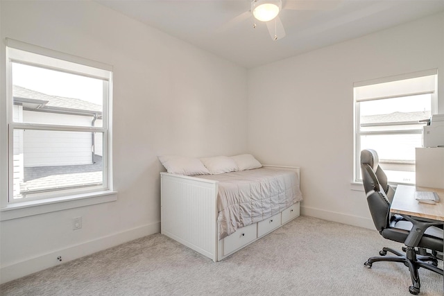 bedroom with ceiling fan, baseboards, and light colored carpet