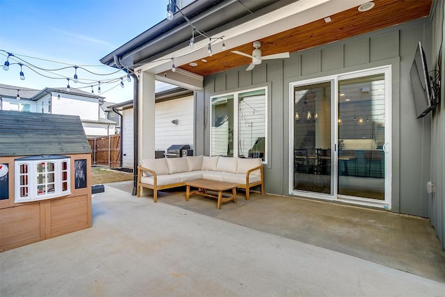 view of patio / terrace featuring a ceiling fan, an outbuilding, fence, and an outdoor living space