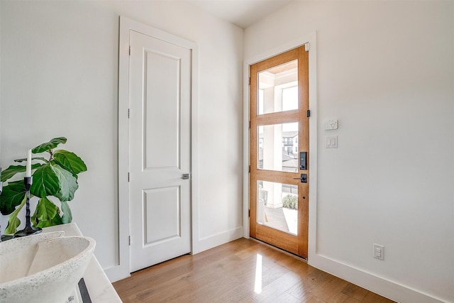 entryway featuring light wood-style floors and baseboards