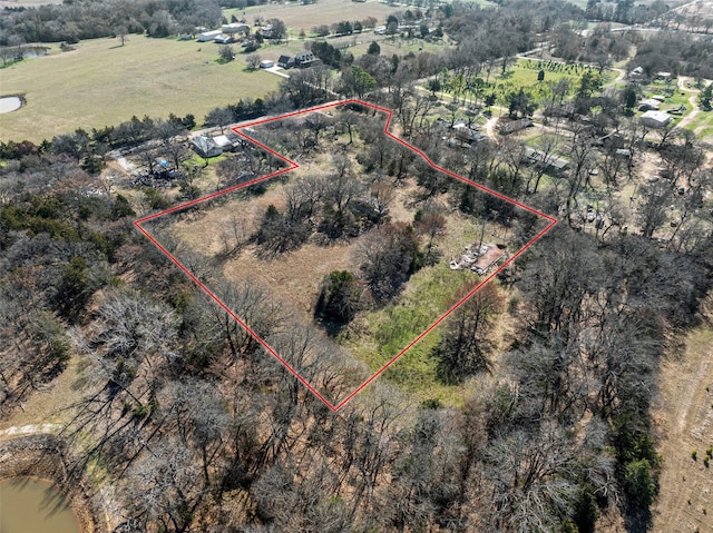 birds eye view of property featuring a water view and a rural view