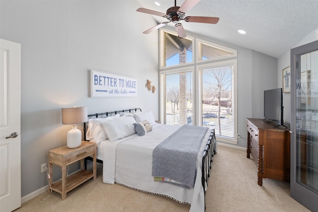 bedroom with lofted ceiling, light carpet, a textured ceiling, and baseboards