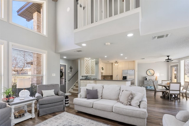 living room featuring recessed lighting, dark wood-style flooring, visible vents, and ceiling fan