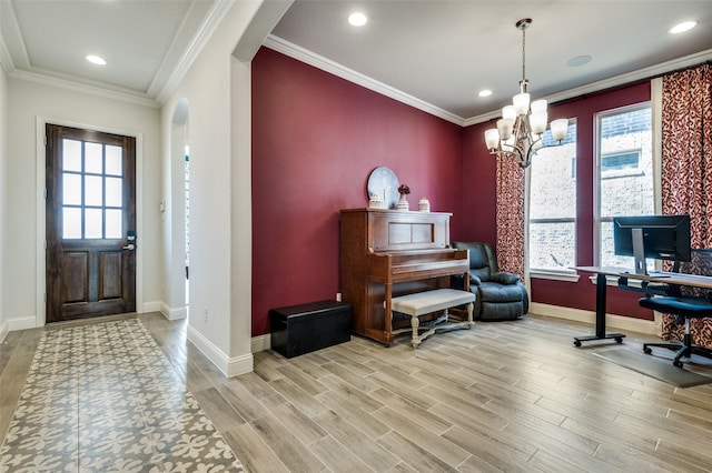 foyer featuring arched walkways, wood finished floors, a wealth of natural light, and crown molding