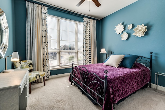 carpeted bedroom featuring ceiling fan and baseboards