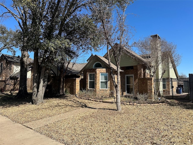 ranch-style home with brick siding and fence