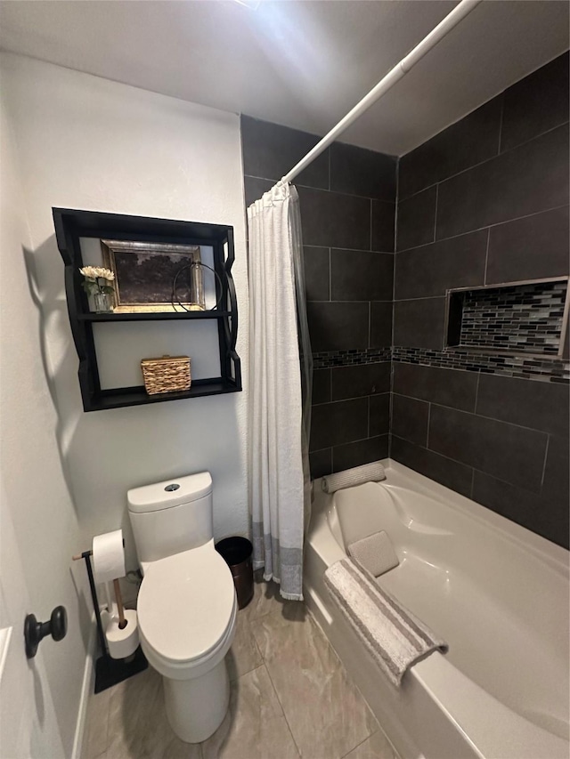 bathroom featuring marble finish floor, baseboards, toilet, and shower / bath combo with shower curtain