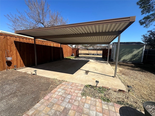 view of parking / parking lot with a shed, fence, and a carport