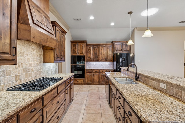 kitchen with light stone counters, a sink, ornamental molding, black appliances, and decorative light fixtures