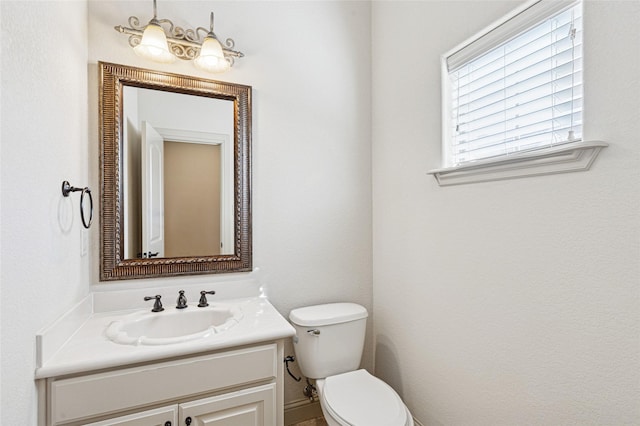 bathroom with toilet and vanity