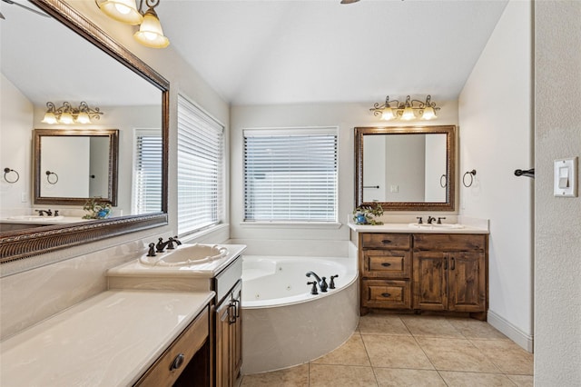 bathroom featuring vaulted ceiling, two vanities, tile patterned flooring, and a sink