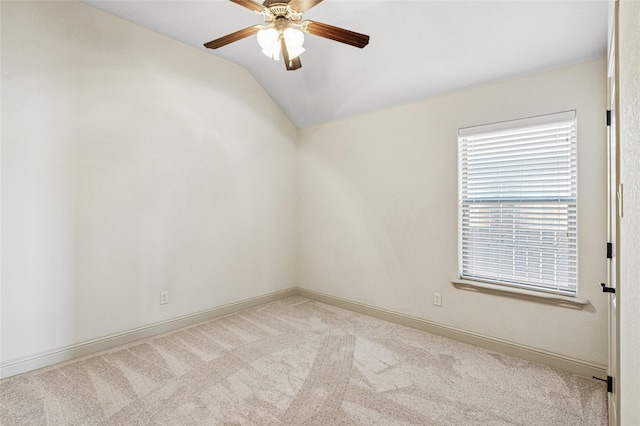 unfurnished room featuring light carpet, ceiling fan, baseboards, and vaulted ceiling