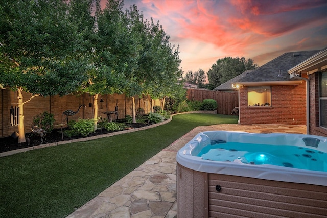 view of pool with a yard, a fenced backyard, and a hot tub