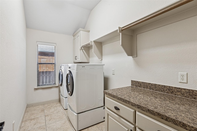 laundry area with cabinet space, light tile patterned floors, baseboards, and independent washer and dryer