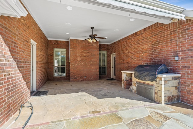 view of patio / terrace with ceiling fan, an outdoor kitchen, and a grill