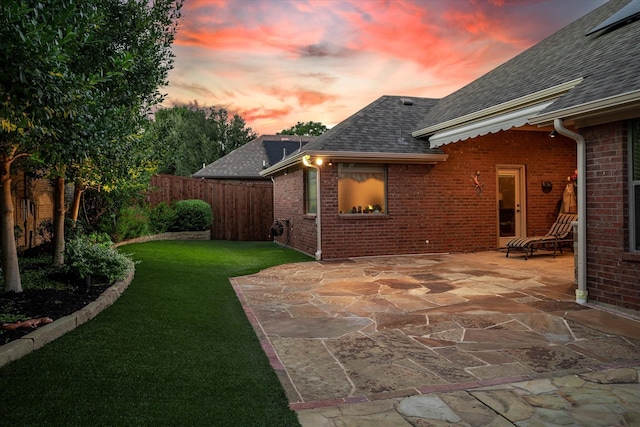 exterior space featuring a patio, a fireplace, and fence