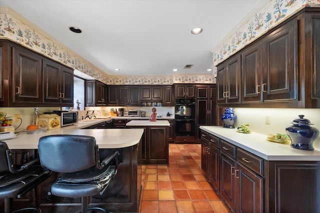 kitchen with dark brown cabinetry, dobule oven black, a sink, a kitchen breakfast bar, and light countertops