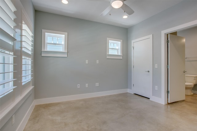 unfurnished bedroom featuring baseboards, concrete flooring, and recessed lighting