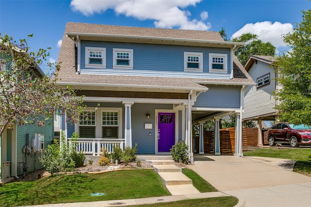 view of front of property featuring roof with shingles, a porch, concrete driveway, a front yard, and a carport