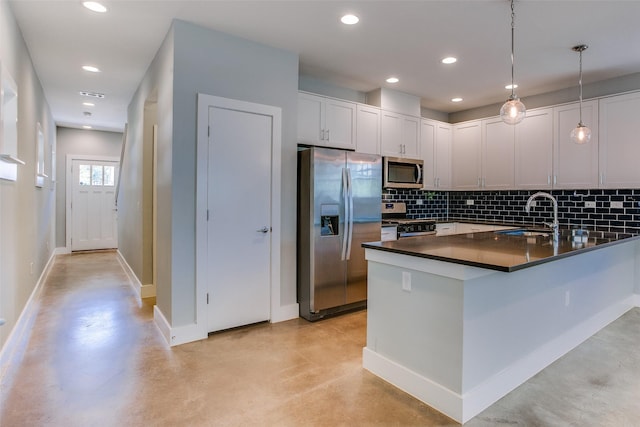 kitchen with stainless steel appliances, concrete floors, a sink, and decorative light fixtures