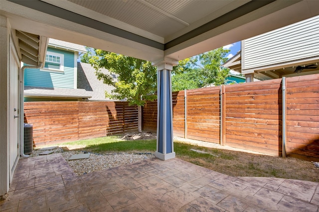 view of patio featuring cooling unit and a fenced backyard