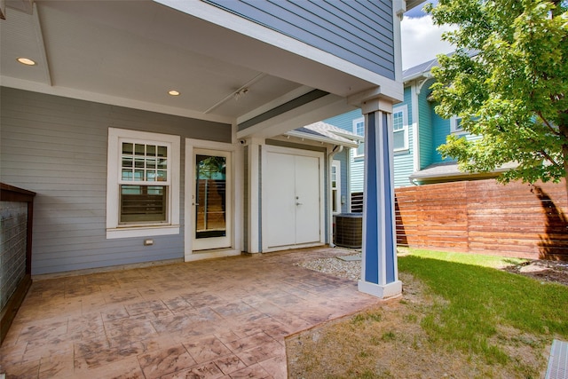 property entrance with a patio area and fence