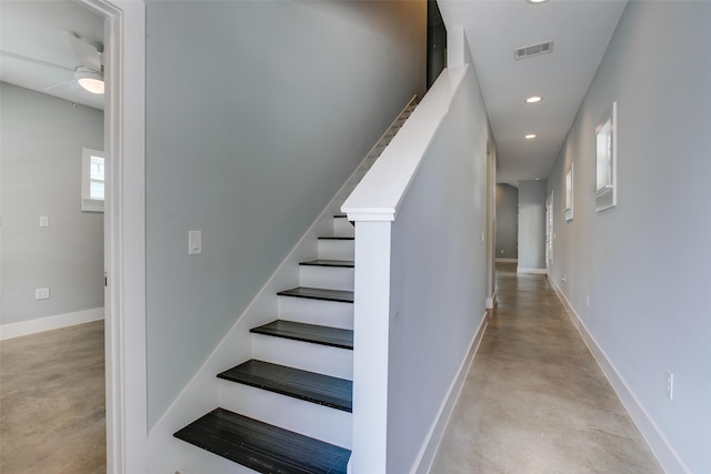 stairway featuring recessed lighting, visible vents, finished concrete flooring, and baseboards