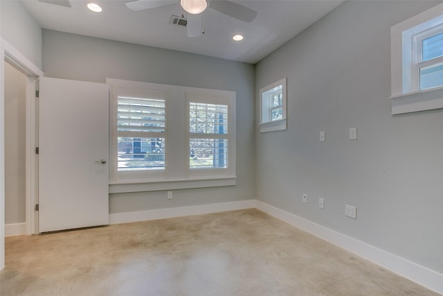 unfurnished room featuring a healthy amount of sunlight, baseboards, visible vents, and recessed lighting