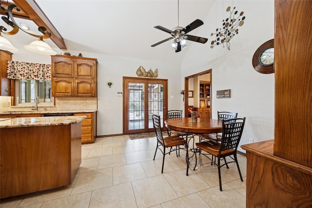 dining room with light tile patterned floors, ceiling fan, high vaulted ceiling, baseboards, and french doors