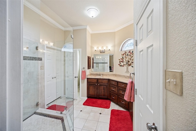 full bathroom with tile patterned flooring, ornamental molding, a tile shower, and vanity