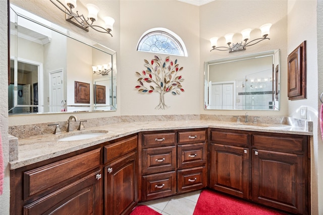 bathroom featuring double vanity, ornamental molding, a sink, and tile patterned floors