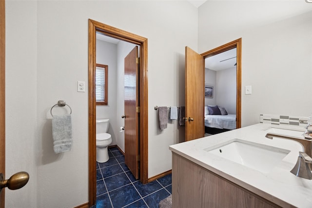 ensuite bathroom with toilet, tile patterned flooring, vanity, and ensuite bathroom