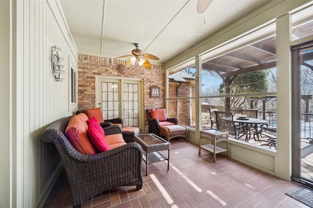 sunroom / solarium with a ceiling fan