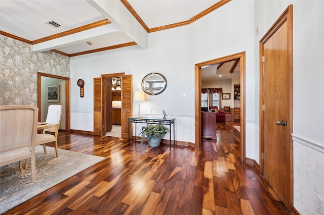 corridor with a wainscoted wall, visible vents, beamed ceiling, dark wood finished floors, and wallpapered walls