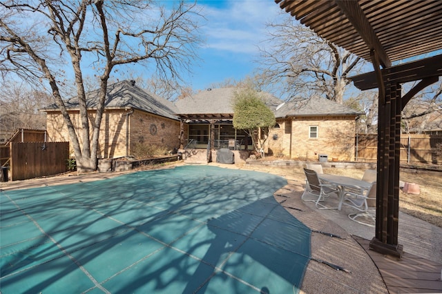 view of swimming pool with a fenced in pool, fence, a pergola, and a patio