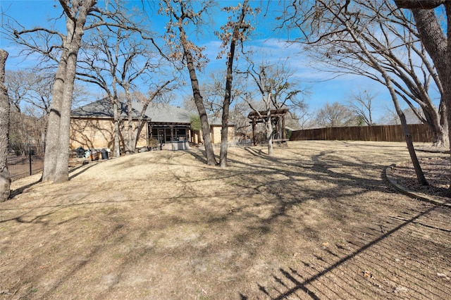 view of yard with fence and a pergola