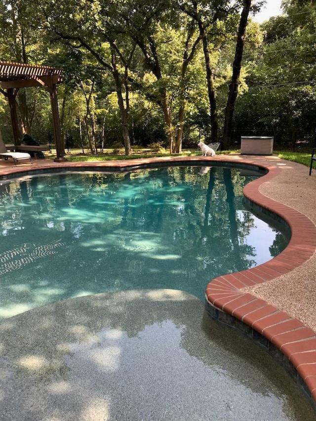 outdoor pool featuring a pergola