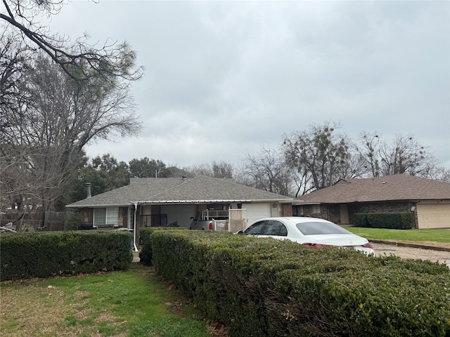 view of property exterior featuring an attached garage and a yard