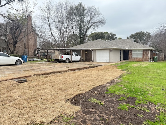 view of yard with a garage and dirt driveway