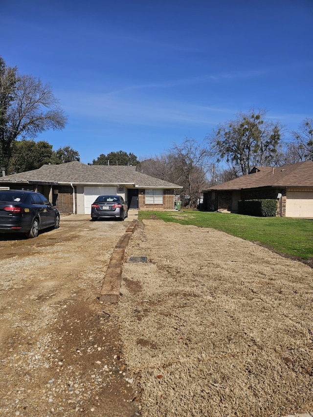 view of yard featuring driveway and an attached garage