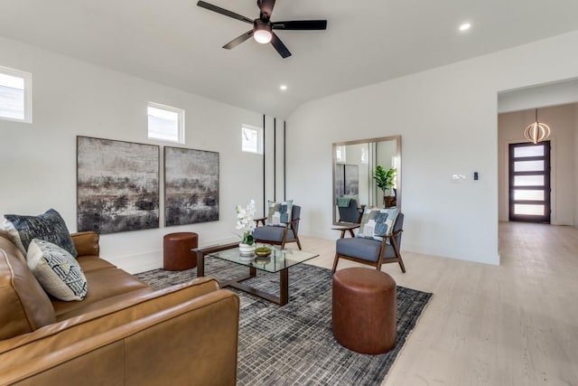 living area with light wood-type flooring, ceiling fan, lofted ceiling, and recessed lighting