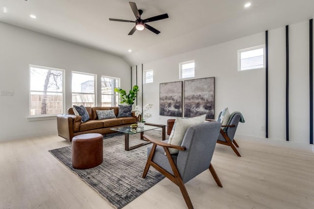 living area featuring recessed lighting, a healthy amount of sunlight, vaulted ceiling, and wood finished floors