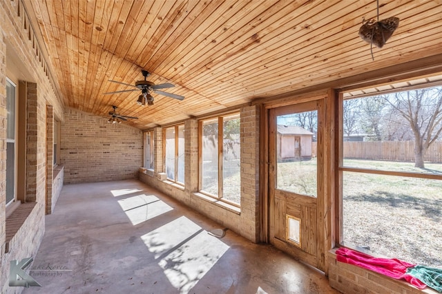 unfurnished sunroom featuring wooden ceiling and vaulted ceiling