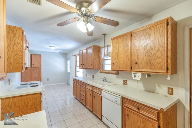 kitchen with light countertops, hanging light fixtures, white dishwasher, and a sink