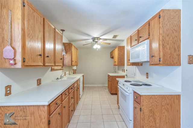 kitchen with white appliances, visible vents, light countertops, and a sink