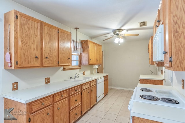 kitchen with white appliances, visible vents, decorative light fixtures, light countertops, and a sink