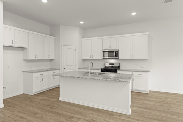 2720 Green River Rd, Royse City, TX 75189 - kitchen with stainless steel appliances, a sink, a center island with sink, white cabinetry, and recessed lighting