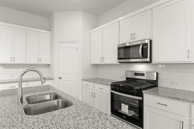 2720 Green River Rd, Royse City, TX 75189 - kitchen with stainless steel appliances, a sink, white cabinets, and decorative backsplash