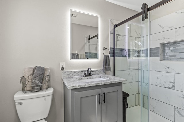 bathroom with toilet, a shower stall, visible vents, and vanity