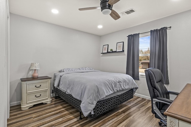 bedroom with baseboards, visible vents, a ceiling fan, dark wood-style floors, and recessed lighting